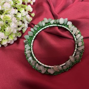 This Gemstone Bangle blends hand-crocheted stainless steel with authentic gemstones on a lightweight aluminium base. The matte finish and artistic stone arrangement create a contemporary bohemian look. Choose your preferred gemstone and wrist size for a personalised piece. Crafted in the UK with hypoallergenic materials for all-day comfort.