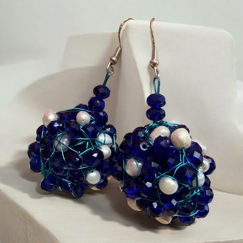 The Crystal and Pearl Drop Earrings blend Czech crystals and freshwater pearls in a handcrafted design. Hypoallergenic with secure hooks (22g each). Customizable for bespoke luxury.